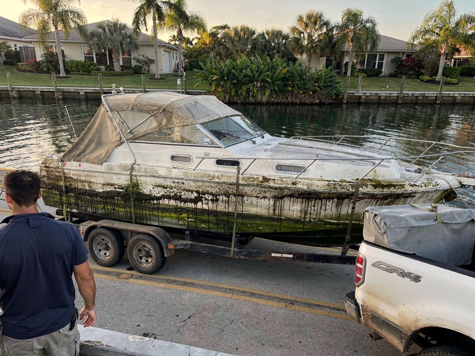 Sunken boat recovery in Plantation, FL: hauled out on a trailer 23 ft Chris-Craft Cavalier hauled out of Plantation, FL on a trailer after the recovery