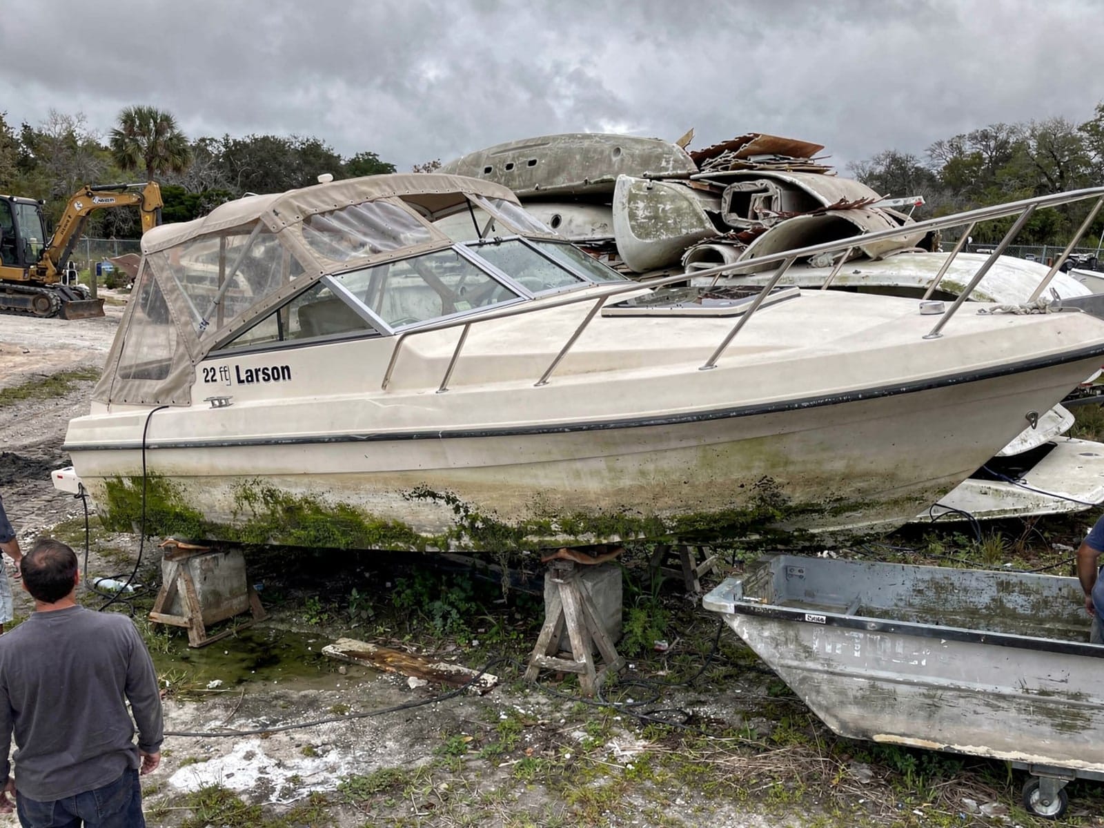 Sunken boat recovery in Sunrise, FL: at the recycling yard 22 ft Larson 220 from Sunrise, FL at the recycling yard after the recovery