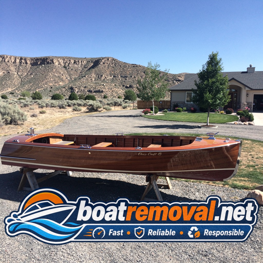 22-foot wooden Chris-Craft runabout resting on wooden stands beside a property near Twin Falls, Idaho