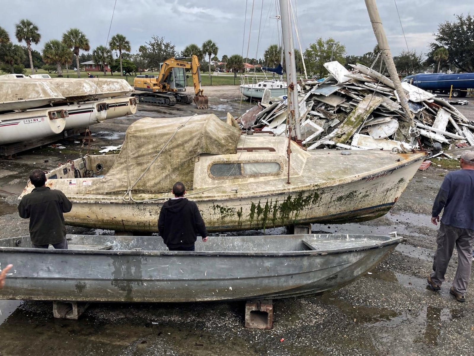 Sunken boat recovery in Aventura, FL: at the recycling yard 27 ft Cal 27 from Aventura, FL at the recycling yard after the recovery