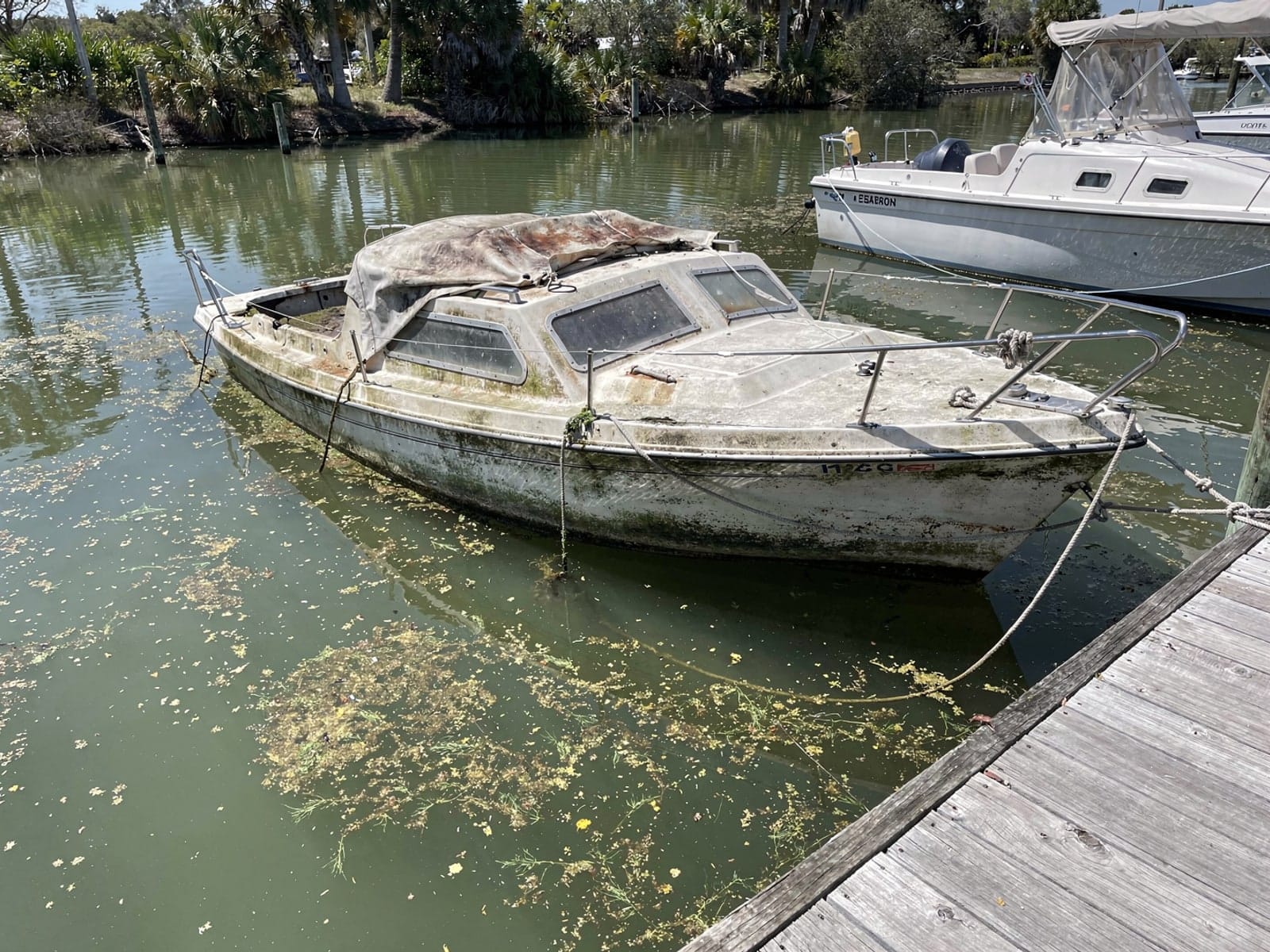 Sunken 26 ft Pearson 26 at a lake dock in Winter Springs, FL