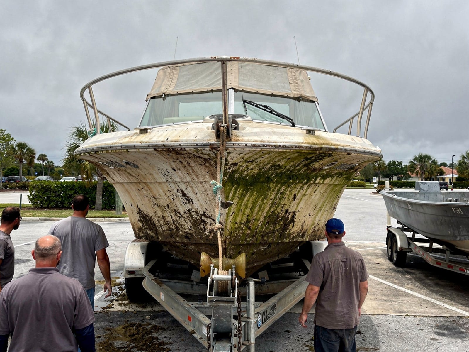 27 ft Chris-Craft Commander 27 pulled out on a trailer at a University, FL boat ramp