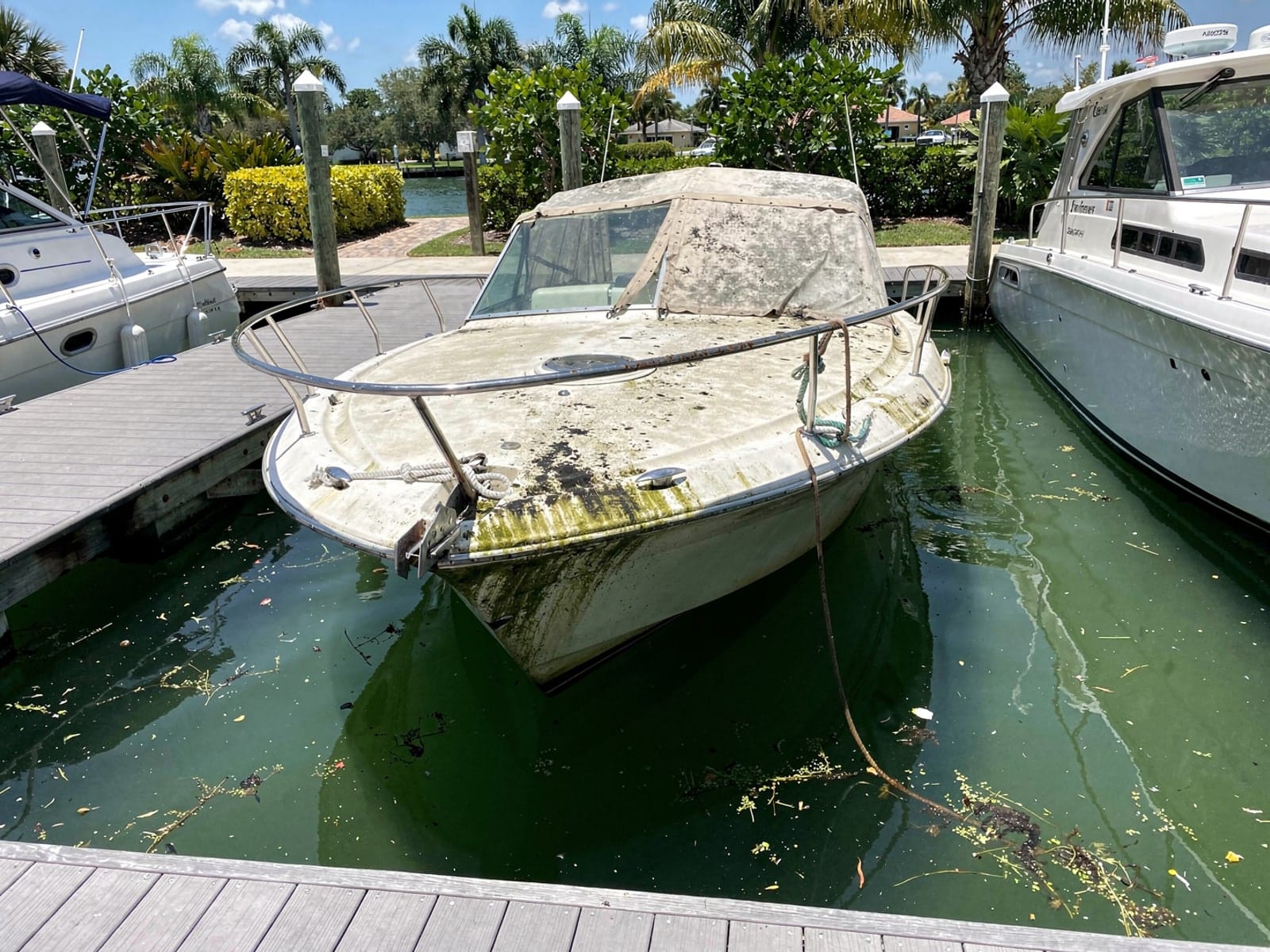 Sunken 27 ft Chris-Craft Commander 27 in a marina slip in University, FL
