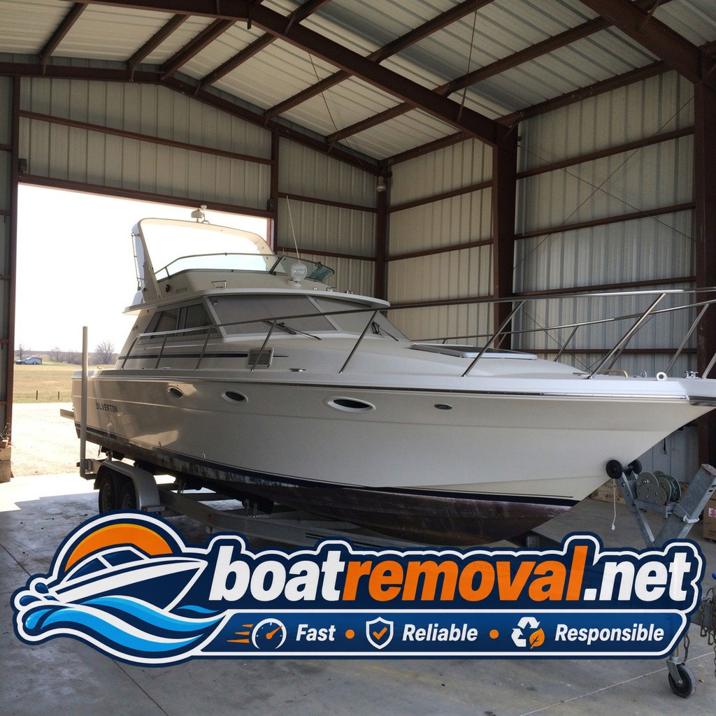 32-foot Silverton cabin cruiser filling half a pole barn near Waverly, Nebraska before removal