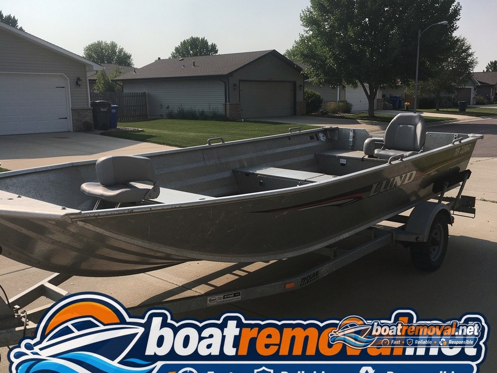 boat removal West Fargo ND, 18 ft Lund aluminum fishing boat on trailer in driveway