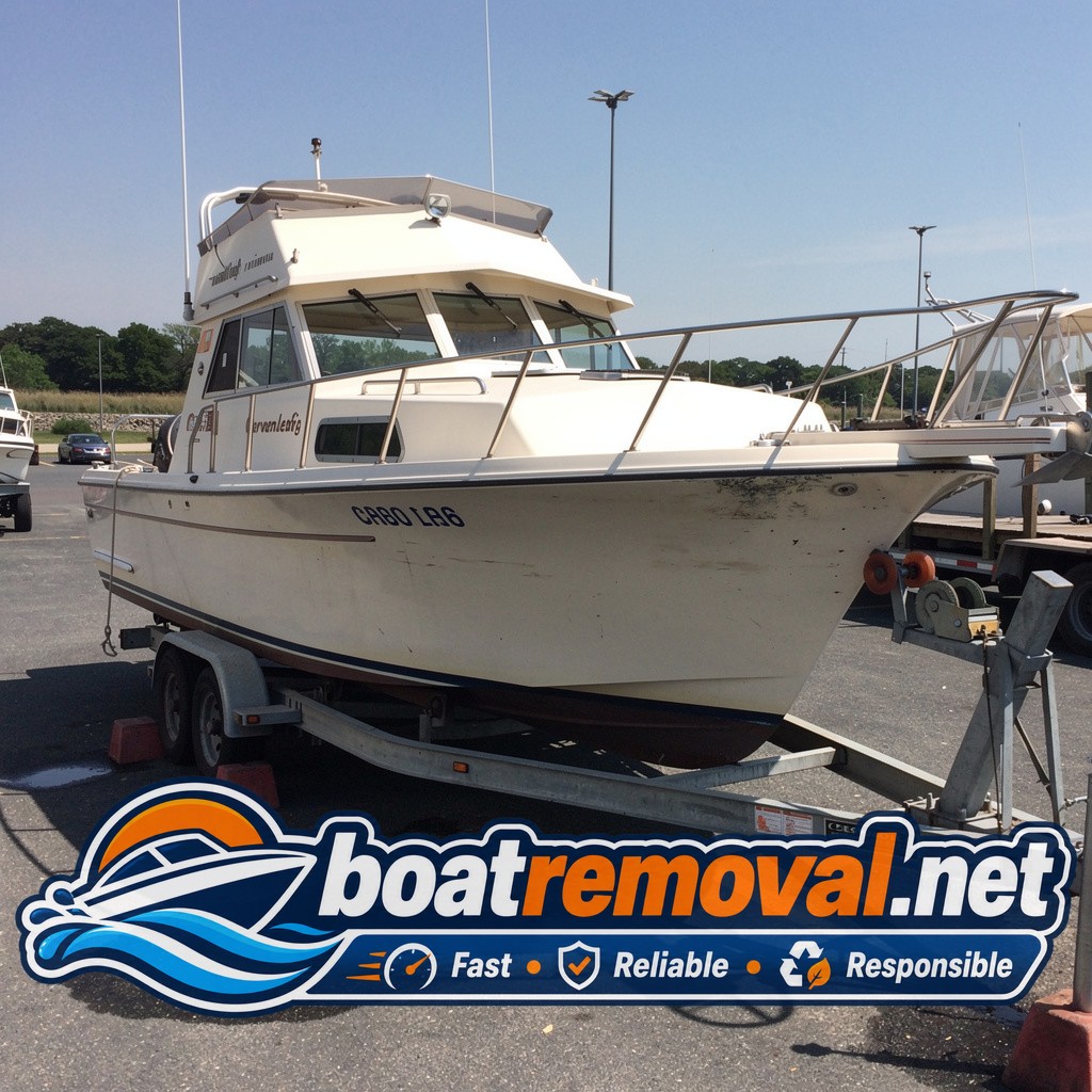 Chris-Craft cabin cruiser loaded onto a trailer after removal from a marina in West Haven, Connecticut