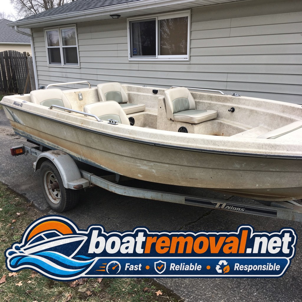 Faded bowrider boat on flat trailer tires parked beside a house