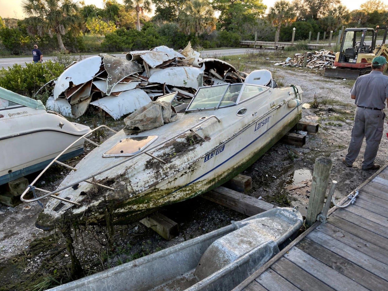 Sunken boat recovery in West Melbourne, FL: at the recycling yard 22 ft Larson 220 from West Melbourne, FL at the recycling yard after the recovery