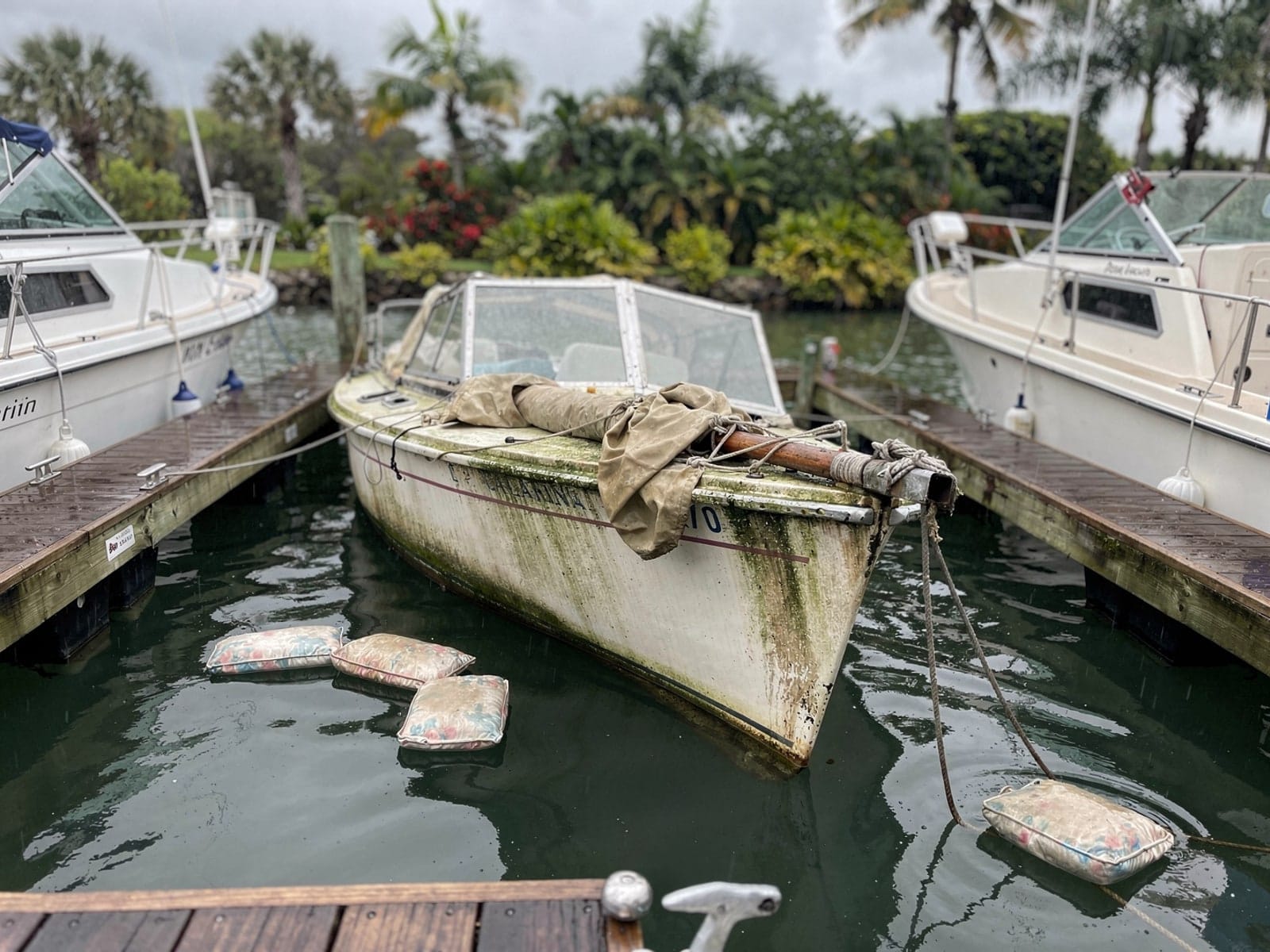 Sunken 22 ft Catalina 22 in a marina slip in West Pensacola, FL