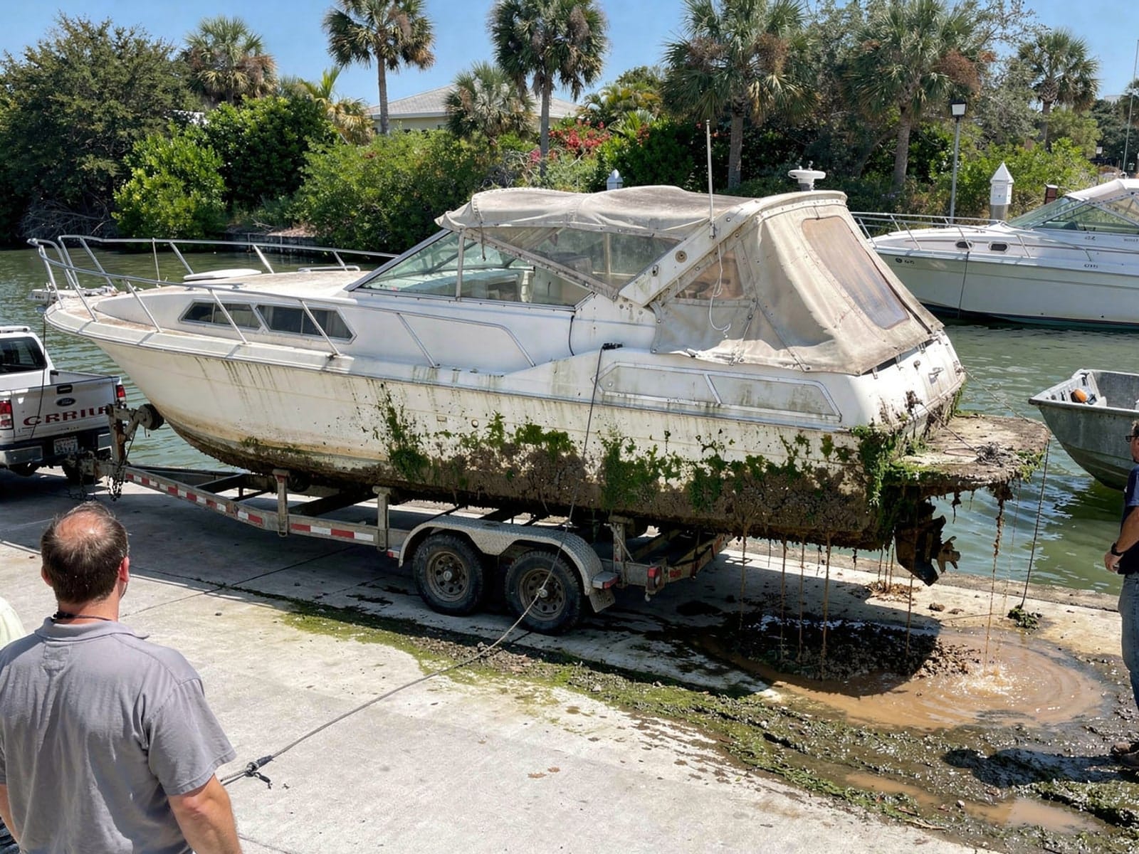 Sunken boat recovery in Weston, FL: pulled out at the ramp 28 ft Carver 28 pulled out on a trailer at a Weston, FL boat ramp