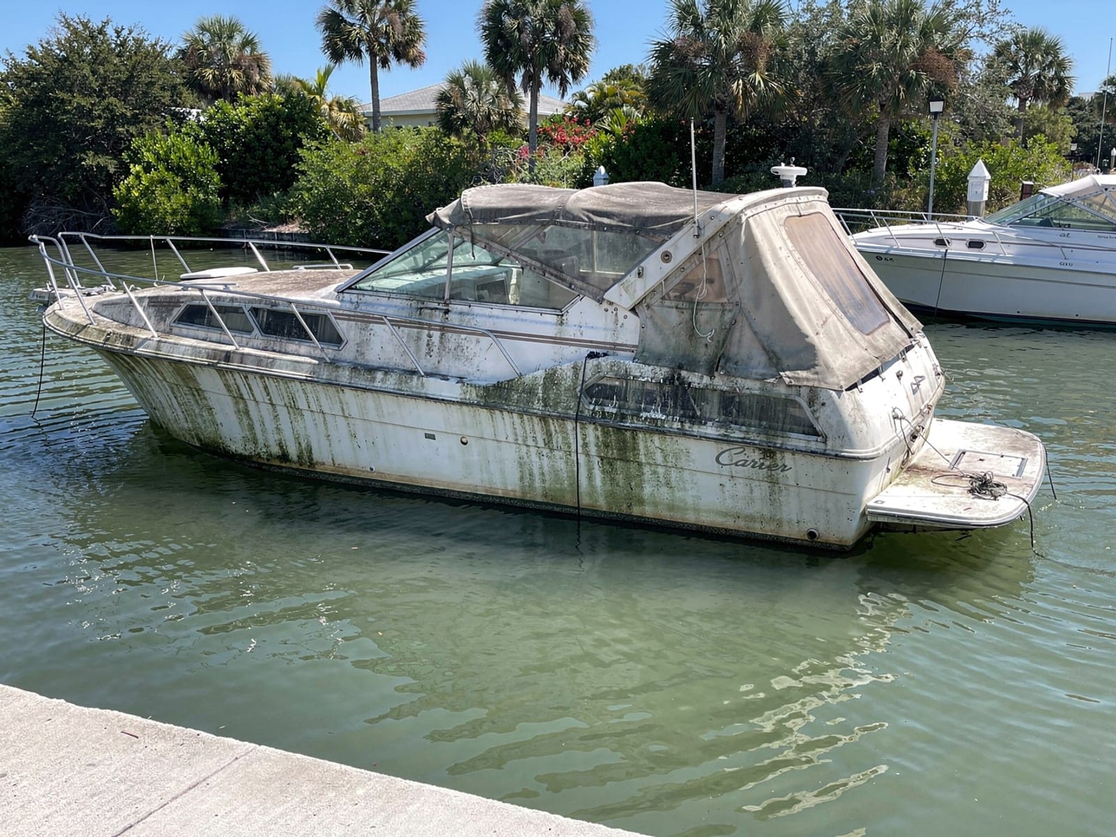 Sunken 28 ft Carver 28 by a boat ramp in Weston, FL