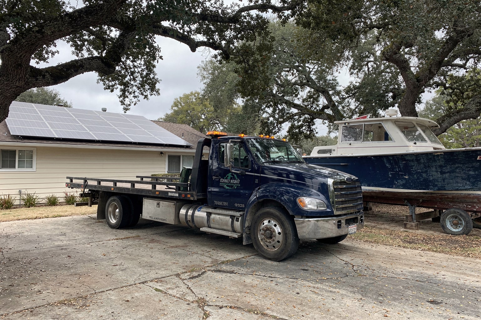 Nationwide Service Areas — flatbed truck hauling a junk boat away